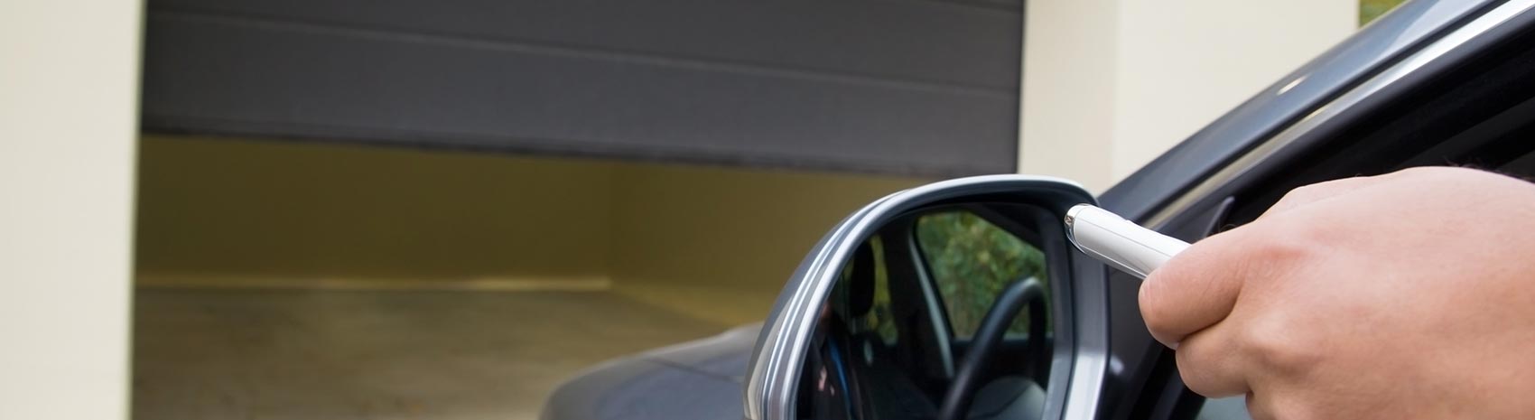 Resident opening their garage door with portable remote