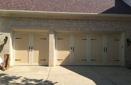 yellow garage doors on white brick garage