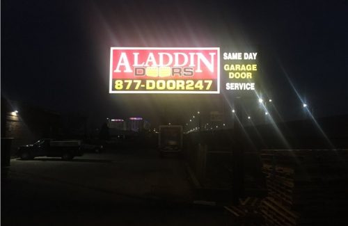 aladdin doors sign lit up at night