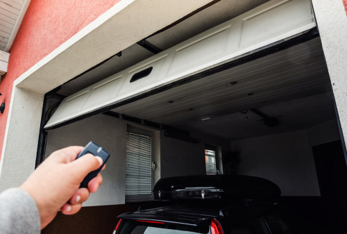 person closing garage door with fob