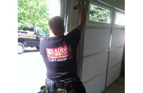 man putting garage door back on track