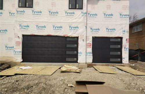 black garage doors on house under construction