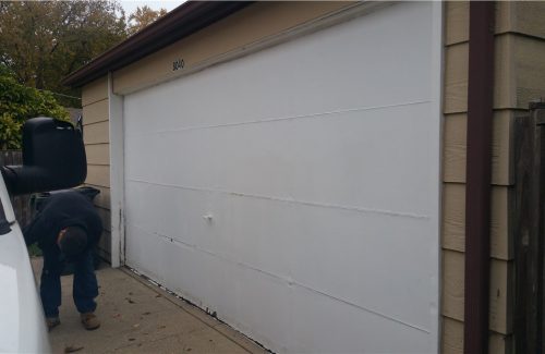 white garage door on tan garage before