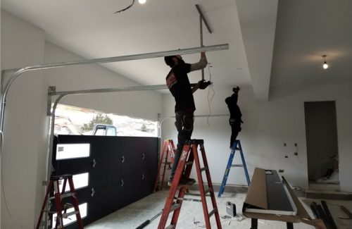 aladdin employees installing garage door tracks