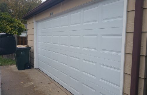 white garage door on tan garage after