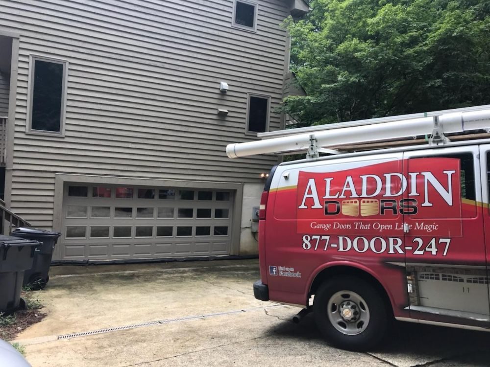 aladdin garage door worker repairing garage door