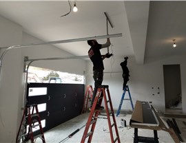 aladdin employees installing garage door tracks